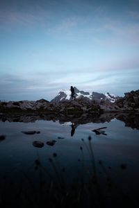 Preview wallpaper lake, mountains, silhouette, stones, shore