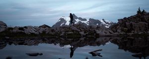 Preview wallpaper lake, mountains, silhouette, stones, shore