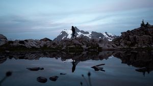 Preview wallpaper lake, mountains, silhouette, stones, shore