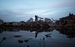 Preview wallpaper lake, mountains, silhouette, stones, shore