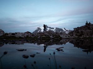 Preview wallpaper lake, mountains, silhouette, stones, shore