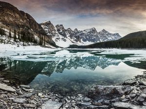 Preview wallpaper lake, mountains, stones, snow, clouds