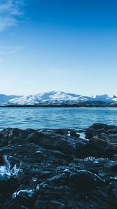 Preview wallpaper lake, mountains, stones, ice, snow, winter, landscape, sky