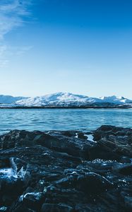 Preview wallpaper lake, mountains, stones, ice, snow, winter, landscape, sky