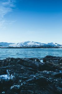 Preview wallpaper lake, mountains, stones, ice, snow, winter, landscape, sky