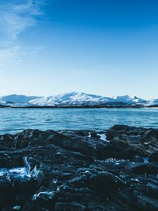 Preview wallpaper lake, mountains, stones, ice, snow, winter, landscape, sky