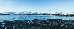 Preview wallpaper lake, mountains, stones, ice, snow, winter, landscape, sky