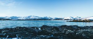 Preview wallpaper lake, mountains, stones, ice, snow, winter, landscape, sky