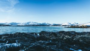 Preview wallpaper lake, mountains, stones, ice, snow, winter, landscape, sky