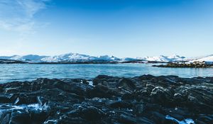 Preview wallpaper lake, mountains, stones, ice, snow, winter, landscape, sky