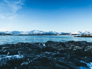 Preview wallpaper lake, mountains, stones, ice, snow, winter, landscape, sky