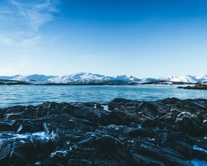 Preview wallpaper lake, mountains, stones, ice, snow, winter, landscape, sky