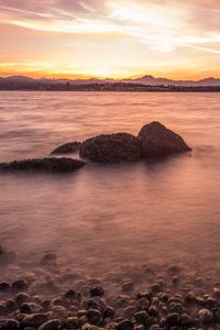 Preview wallpaper lake, pebbles, stones, hills, sunrise