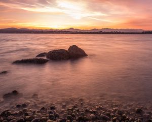 Preview wallpaper lake, pebbles, stones, hills, sunrise