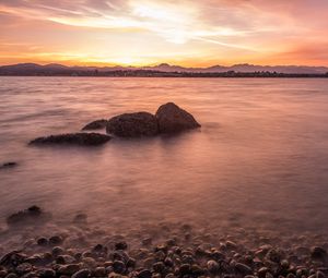 Preview wallpaper lake, pebbles, stones, hills, sunrise