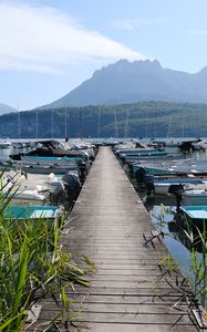 Preview wallpaper lake, pier, boats, mountains, fog, clouds