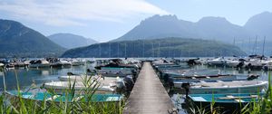 Preview wallpaper lake, pier, boats, mountains, fog, clouds