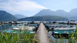 Preview wallpaper lake, pier, boats, mountains, fog, clouds