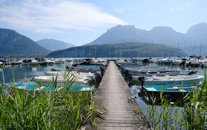 Preview wallpaper lake, pier, boats, mountains, fog, clouds