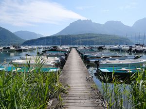 Preview wallpaper lake, pier, boats, mountains, fog, clouds