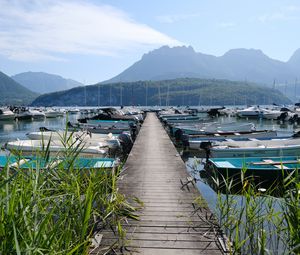 Preview wallpaper lake, pier, boats, mountains, fog, clouds