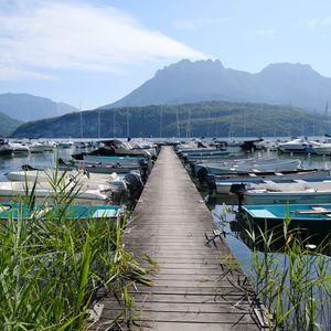 Preview wallpaper lake, pier, boats, mountains, fog, clouds