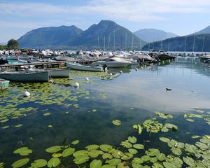 Preview wallpaper lake, pier, boats, mountains, water lilies, nature