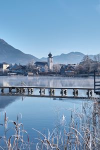 Preview wallpaper lake, pier, buildings, mountains, shore