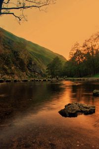 Preview wallpaper lake, pond, stones, trees, twilight, grass, evening