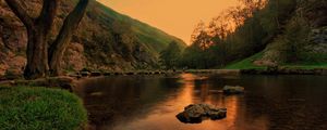 Preview wallpaper lake, pond, stones, trees, twilight, grass, evening