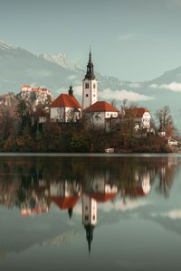 Preview wallpaper lake, shore, buildings, mountains, forest, water