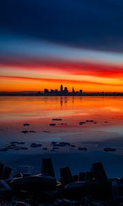 Preview wallpaper lake, shore, city, buildings, sunset, dusk, dark