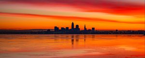 Preview wallpaper lake, shore, city, buildings, sunset, dusk, dark