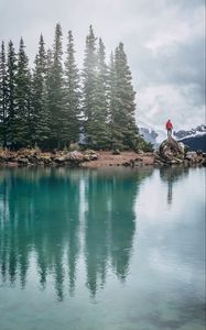 Preview wallpaper lake, shore, trees, stones, silhouette, mountains