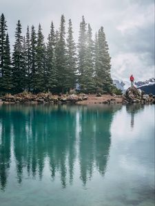 Preview wallpaper lake, shore, trees, stones, silhouette, mountains