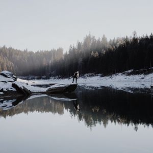 Preview wallpaper lake, silhouette, stone, snow, trees, reflection