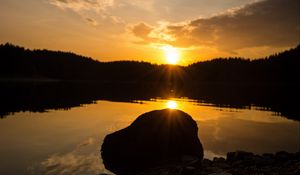 Preview wallpaper lake, stone, sunset, reflection, sun, sky, forest, coast