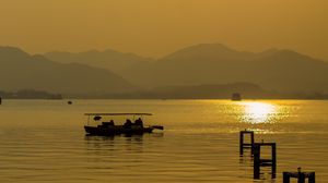 Preview wallpaper lake, sunset, boat, horizon
