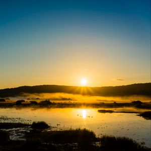 Preview wallpaper lake, sunset, grass, sky, shadows