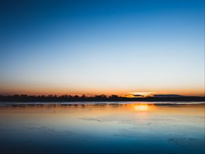 Preview wallpaper lake, sunset, horizon, distant, twilight, clear sky