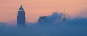 Preview wallpaper lake, trees, city, skyscrapers, fog, clouds