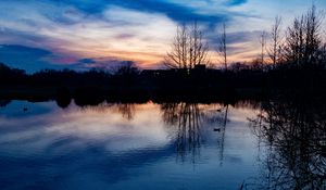Preview wallpaper lake, trees, silhouettes, sunset, clouds, nature, dark