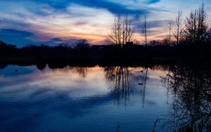 Preview wallpaper lake, trees, silhouettes, sunset, clouds, nature, dark