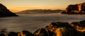 Preview wallpaper lake, water, rocks, stones, sunset, nature, landscape