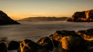 Preview wallpaper lake, water, rocks, stones, sunset, nature, landscape