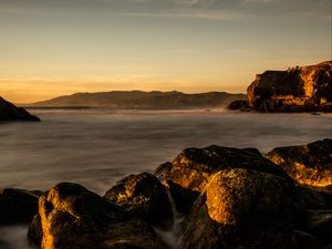 Preview wallpaper lake, water, rocks, stones, sunset, nature, landscape