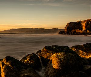 Preview wallpaper lake, water, rocks, stones, sunset, nature, landscape