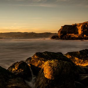 Preview wallpaper lake, water, rocks, stones, sunset, nature, landscape