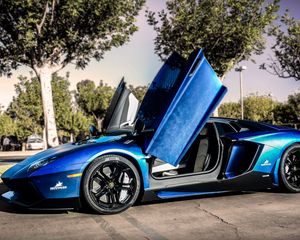 Preview wallpaper lamborghini, aventador, blue, street, trees