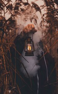 Preview wallpaper lamp, hand, smoke, man, grass, lantern